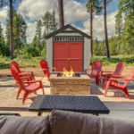 Outdoor Wood Storage Shed , A cozy fire pit surrounded by red chairs, positioned in front of a rustic shed, creating a warm outdoor gathering space.