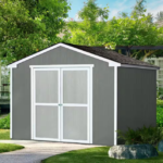 10x10 Outdoor Wood Storage Shed A gray garden shed with white double doors in a lush green yard, showcasing a spacious Outdoor Wood Storage Shed with dimensions similar to a 10x10 storage shed.