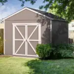 10x12 Backyard Wood Storage Shed ,Do-It-Yourself Rookwood 120 sq. ft ,A small shed nestled in a backyard, surrounded by a wooden fence, creating a cozy outdoor space